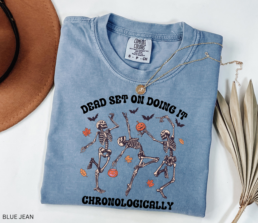History teacher Halloween shirt with dancing skeletons, pumpkins, bats, and autumn leaves. Funny spooky season tee for teachers and classrooms.