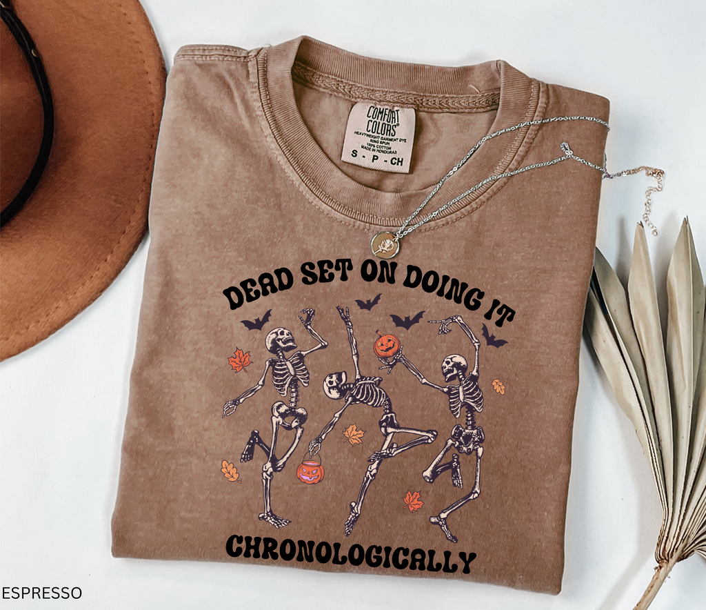 History teacher Halloween shirt with dancing skeletons, pumpkins, bats, and autumn leaves. Funny spooky season tee for teachers and classrooms.
