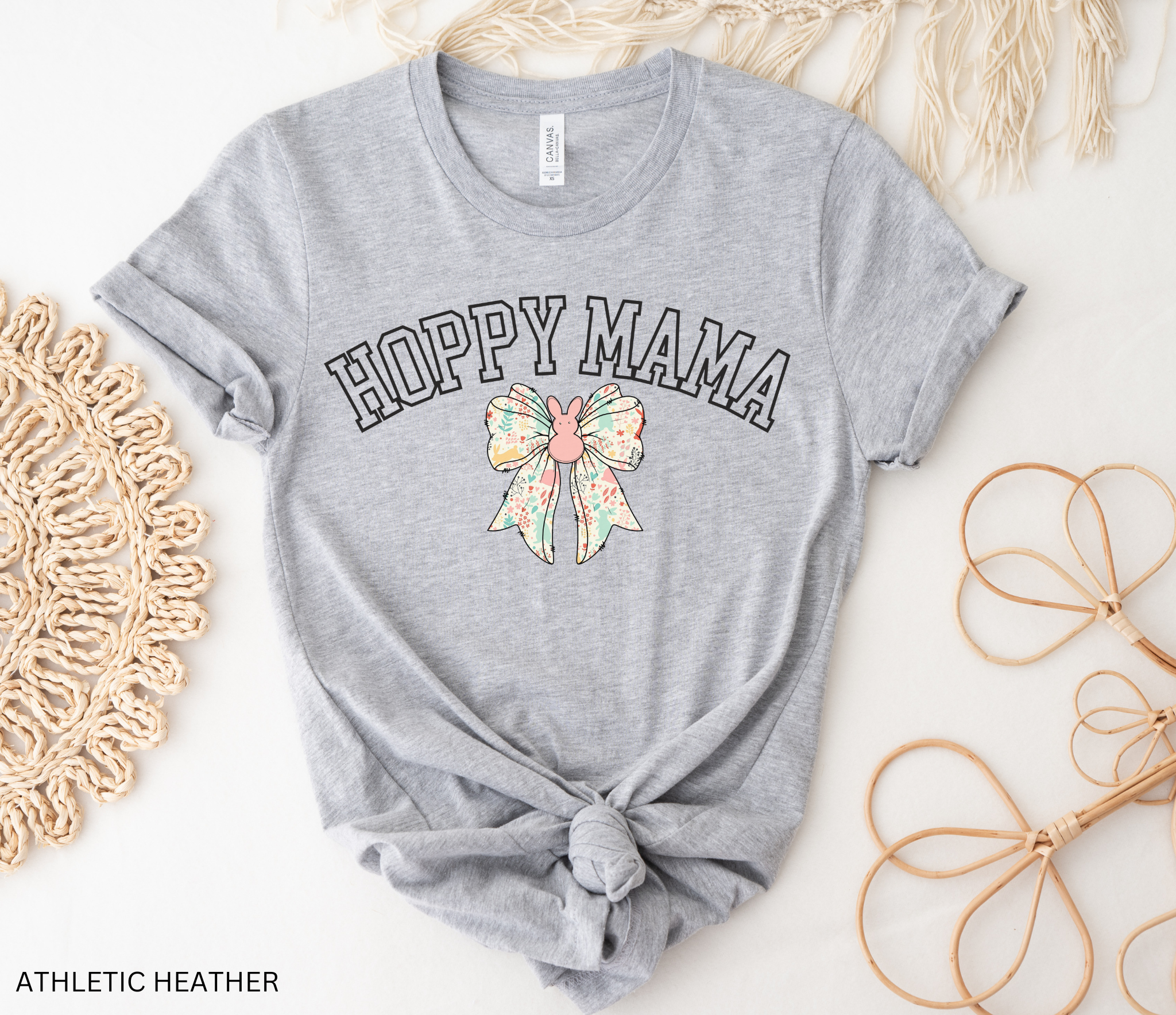 Hoppy Mama Easter shirt with pastel floral bunny bow design on a black background