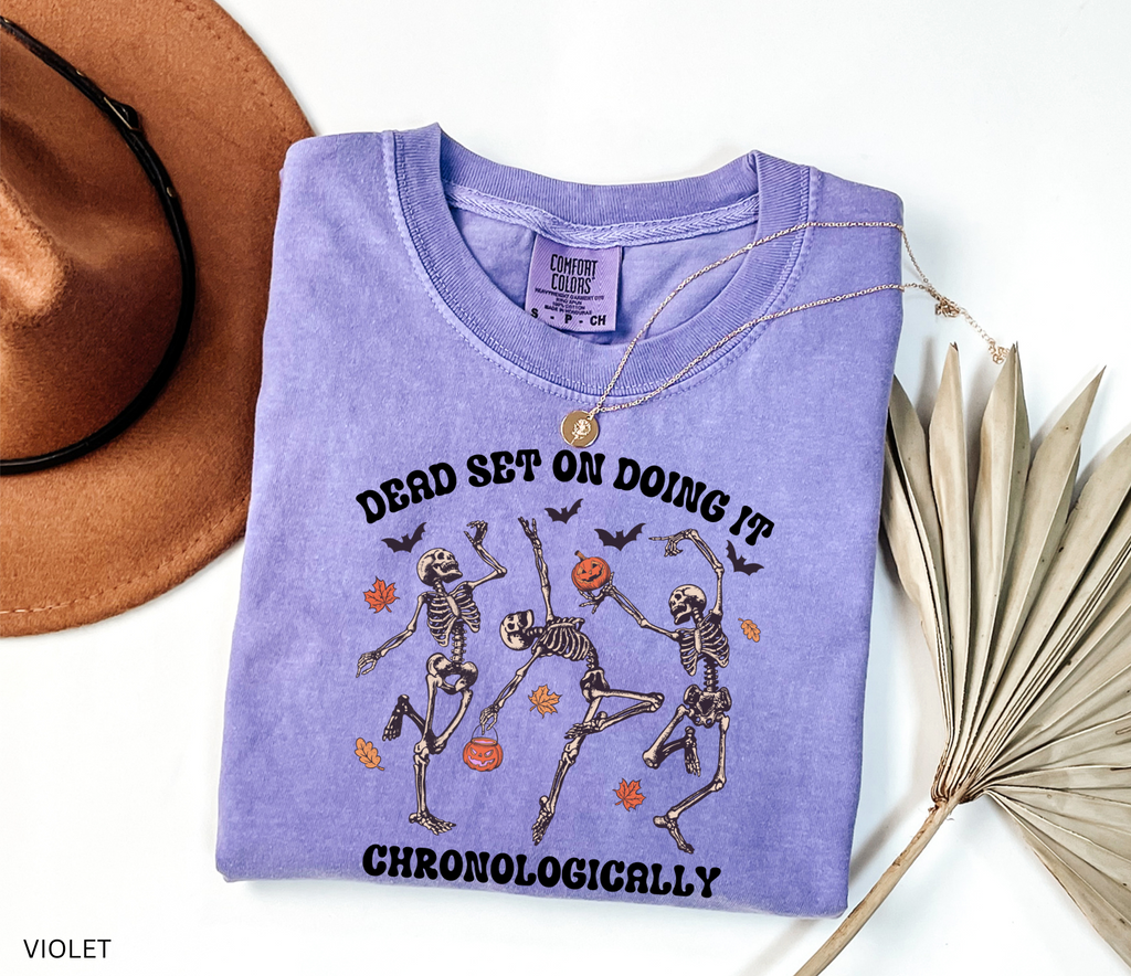 History teacher Halloween shirt with dancing skeletons, pumpkins, bats, and autumn leaves. Funny spooky season tee for teachers and classrooms.