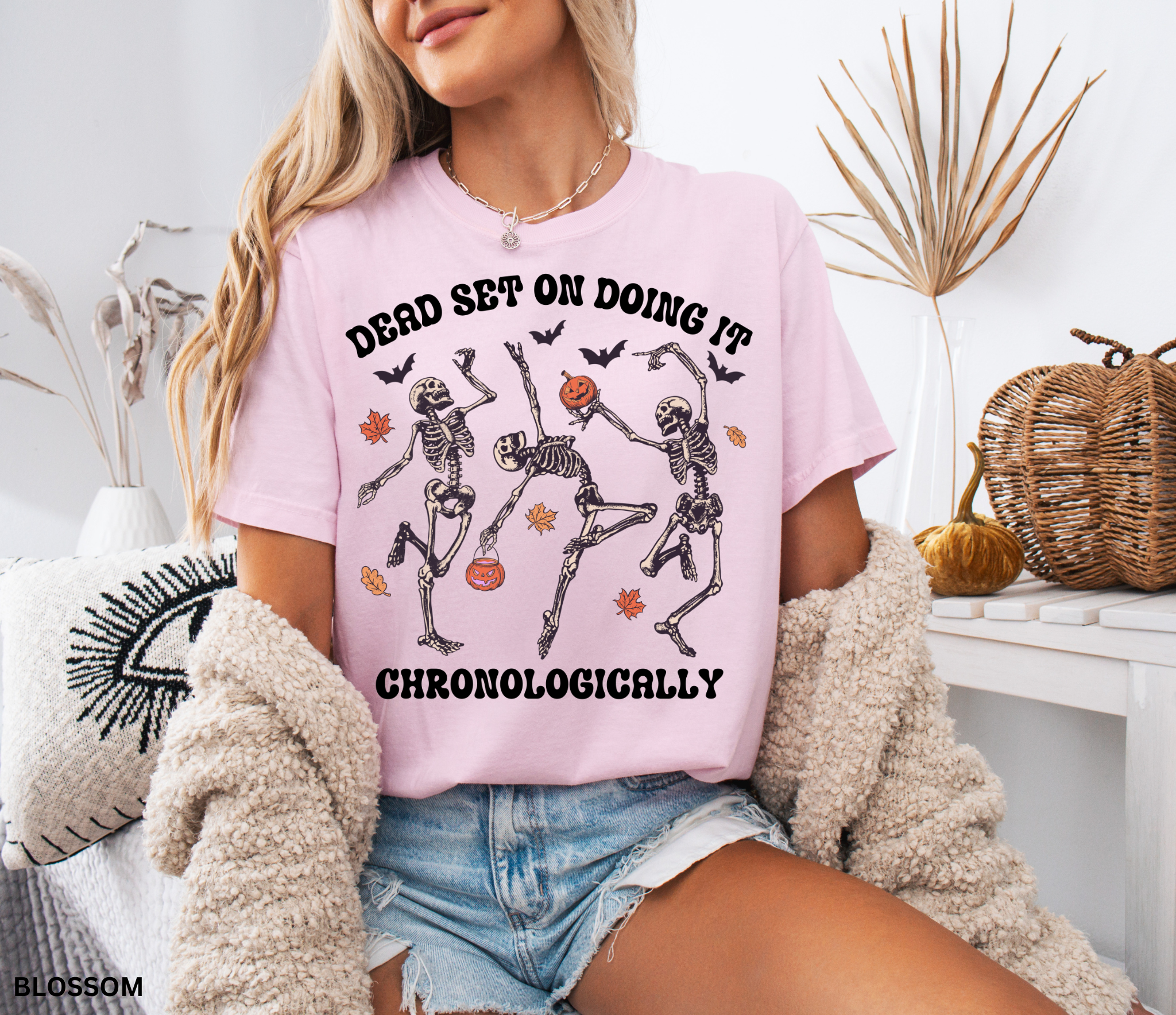 History teacher Halloween shirt with dancing skeletons, pumpkins, bats, and autumn leaves. Funny spooky season tee for teachers and classrooms.