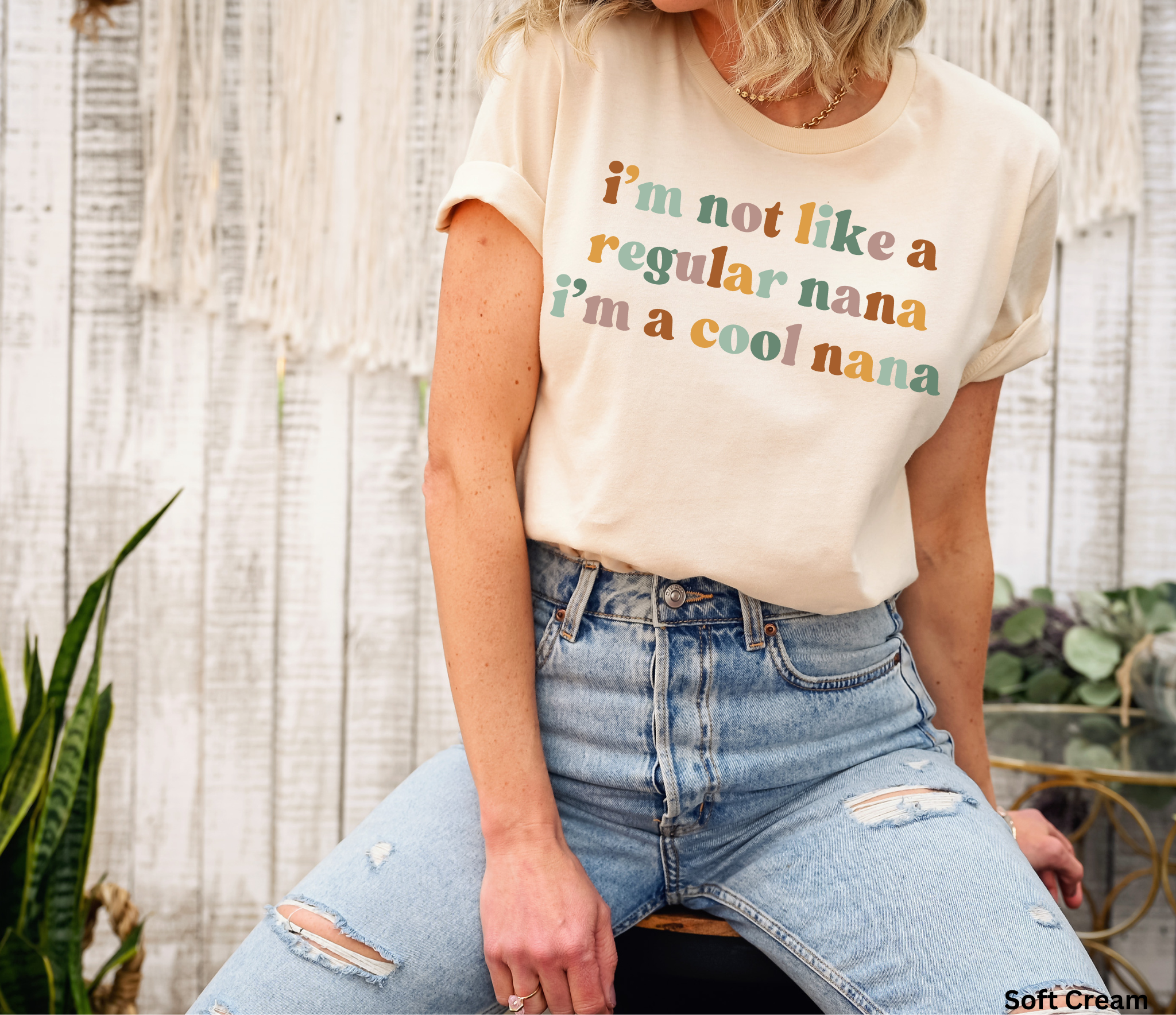 Retro-style text reading “I’m not like a regular nana, I’m a cool nana” in warm pastel colours on a black background.