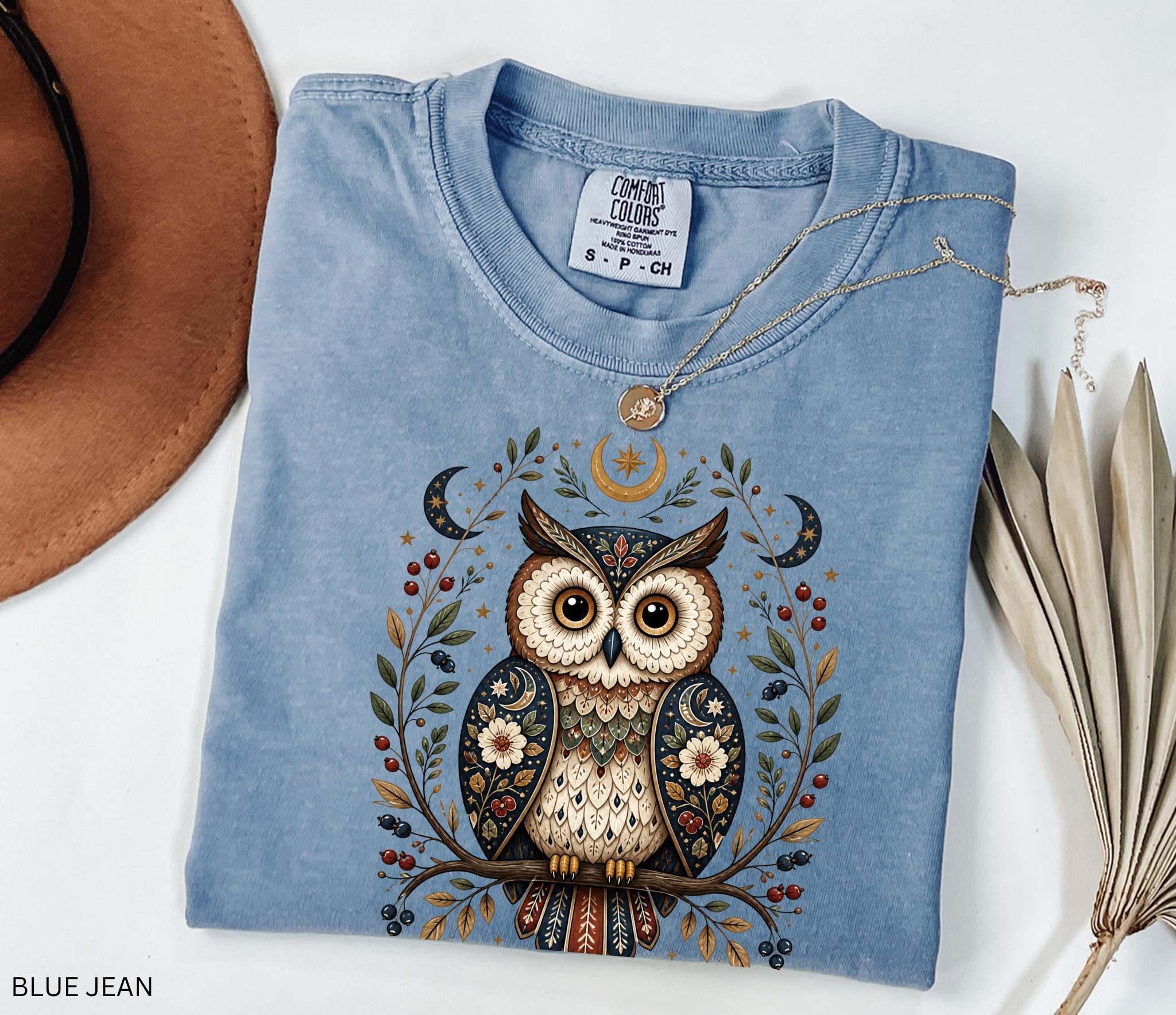 Whimsical celestial owl illustration with moon phases, stars, berries, and floral folk-art details in a woodland cottagecore fantasy aesthetic.