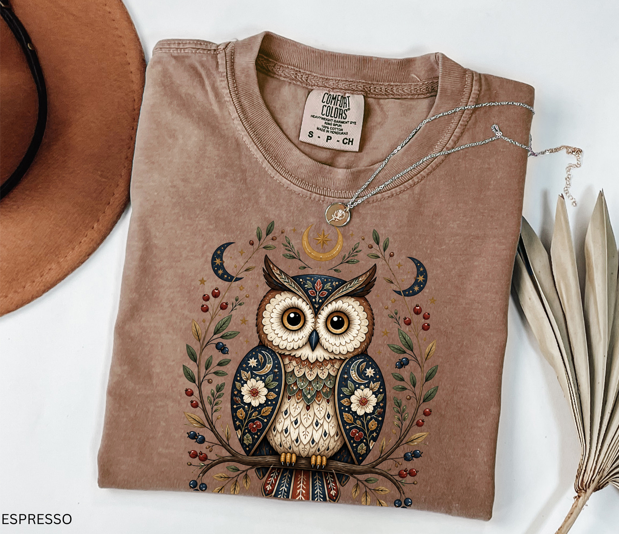 Whimsical celestial owl illustration with moon phases, stars, berries, and floral folk-art details in a woodland cottagecore fantasy aesthetic.