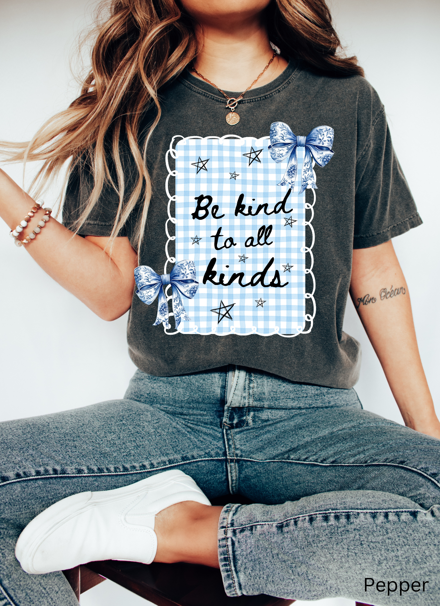 Blue gingham “Be Kind to All Kinds” shirt with bows and stars – kindness graphic tee for teachers and educators.