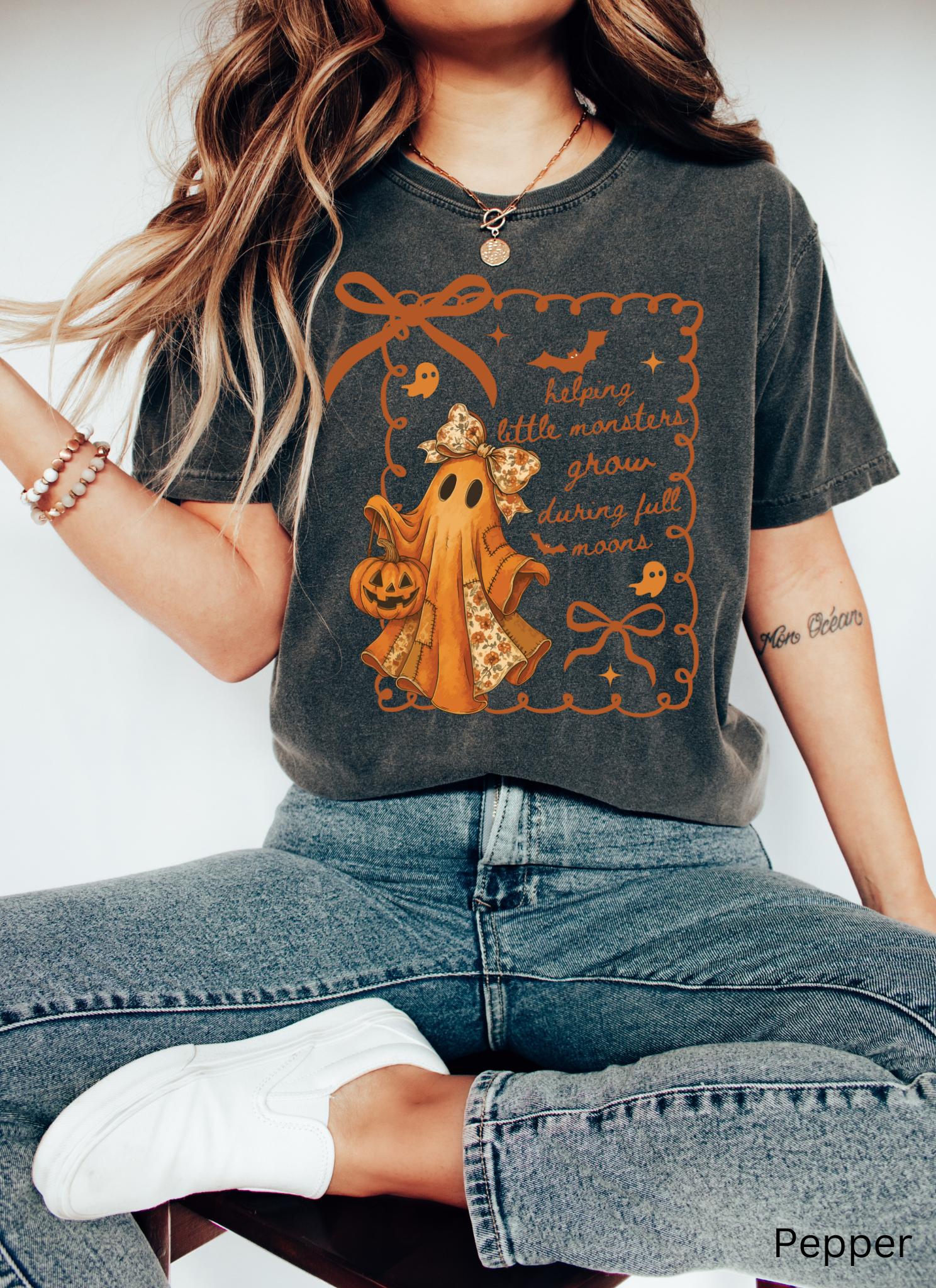 Halloween daycare teacher shirt with an orange patchwork ghost wearing a floral bow, holding a jack-o’-lantern pumpkin bucket.