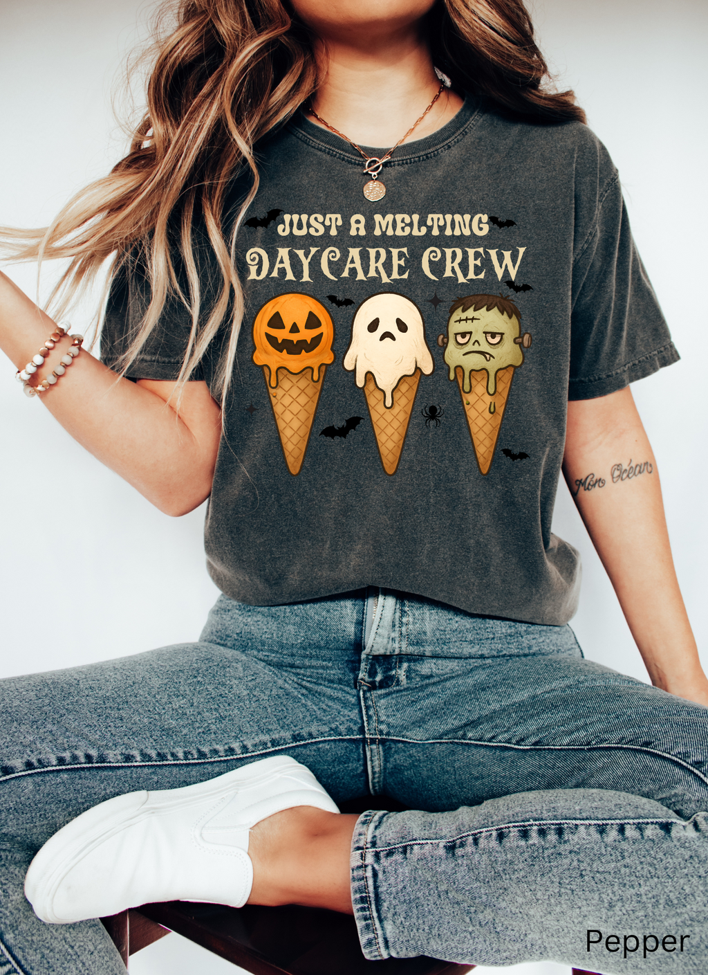 Daycare teacher Halloween shirt with three ice cream cones designed as a pumpkin, ghost, and Frankenstein monster, with the phrase “Just a Melting Daycare Crew.”