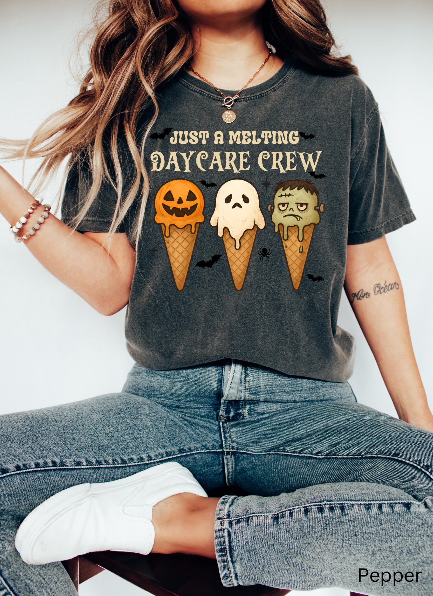 Daycare teacher Halloween shirt with three ice cream cones designed as a pumpkin, ghost, and Frankenstein monster, with the phrase “Just a Melting Daycare Crew.”
