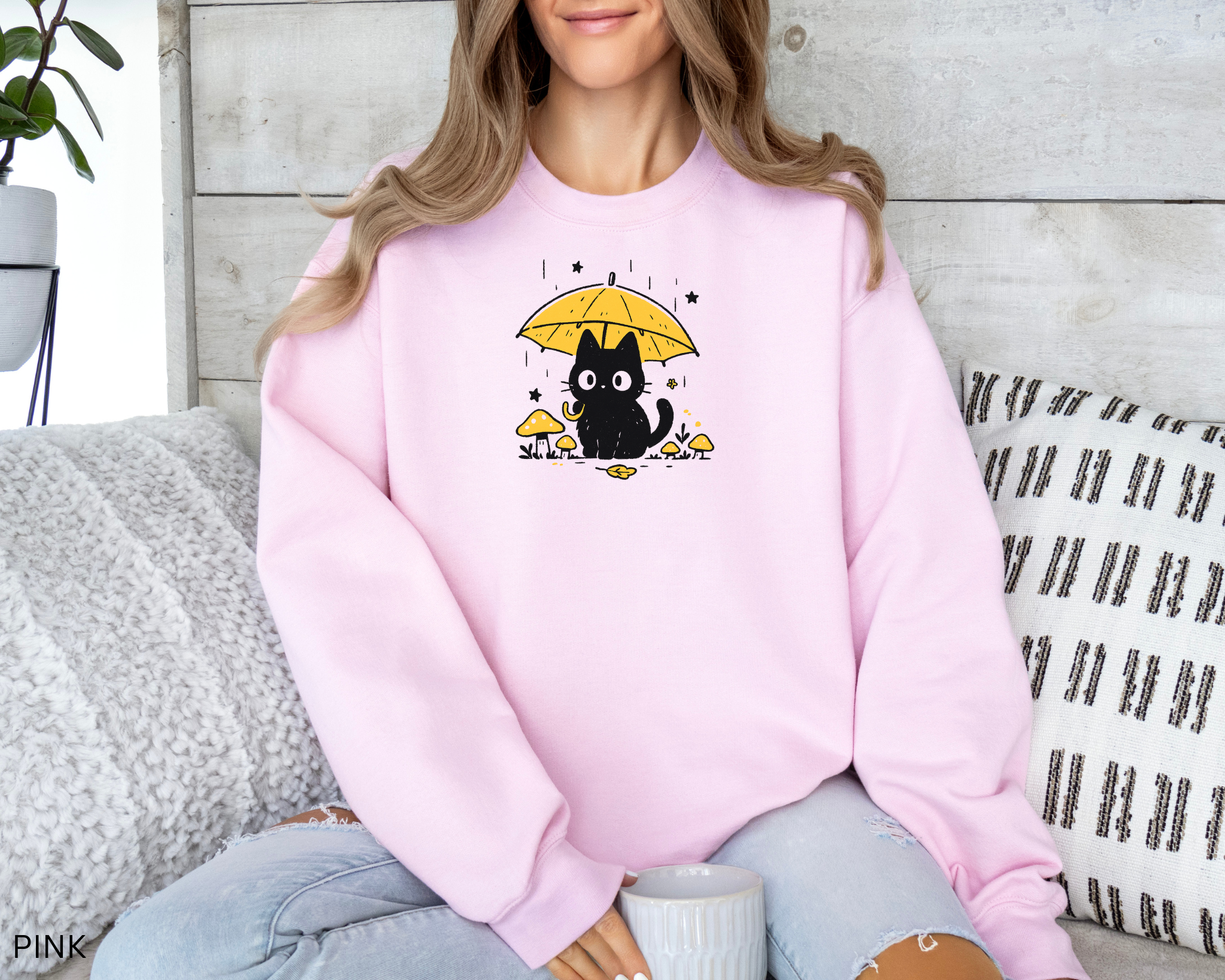 Cozy cat lover sweatshirt with kawaii black cat holding an umbrella among mushrooms