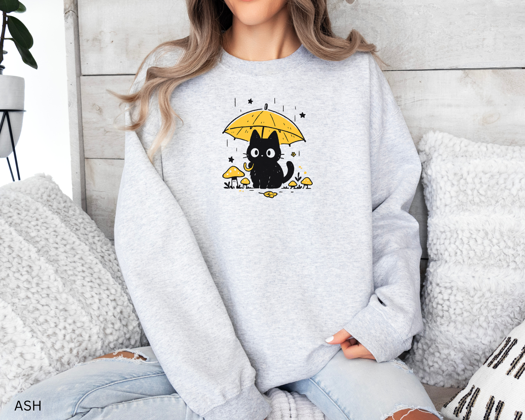 Cozy cat lover sweatshirt with kawaii black cat holding an umbrella among mushrooms